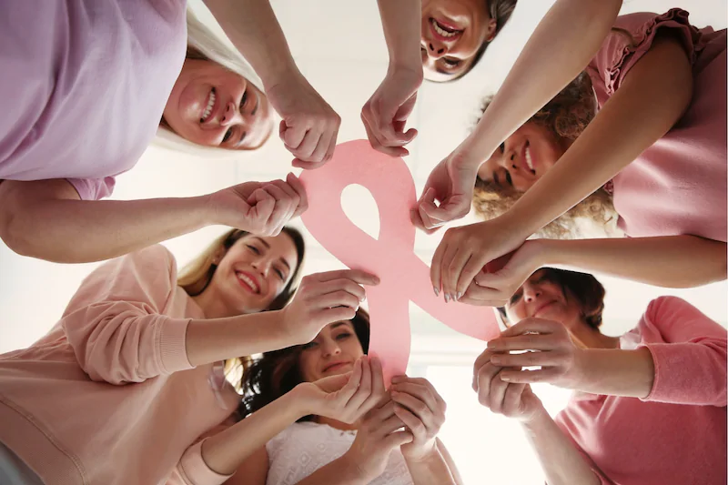 Women supporting pink cross band