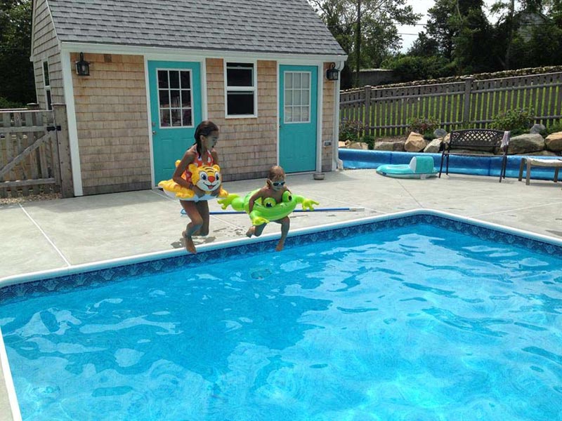 two kids jumping into pool