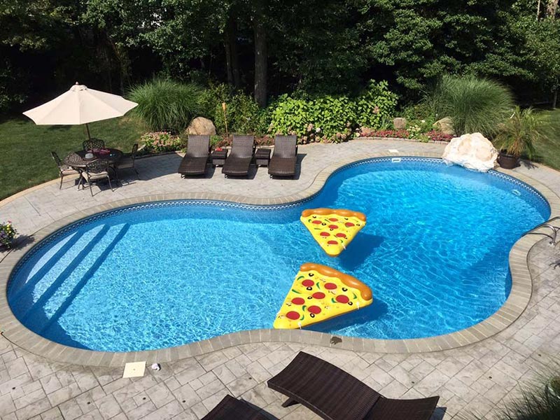 in ground pool with pizza floaties