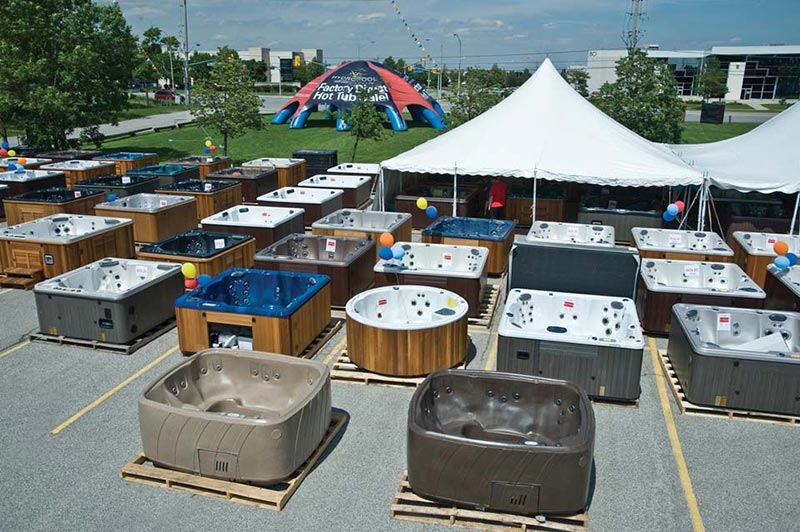 parking lot filled with hot tubs on display